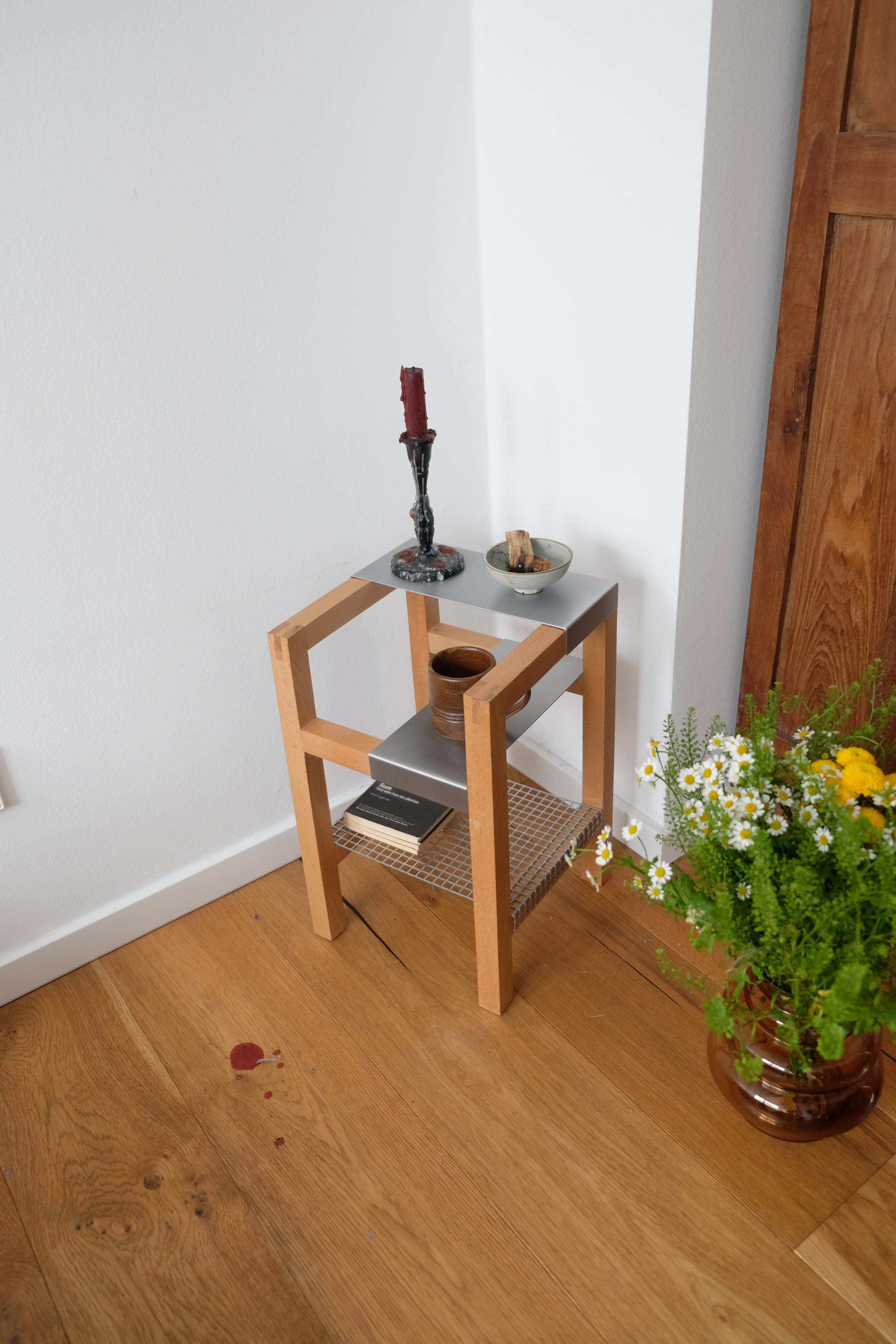 Woman in white dress and gold earrings walking down runway
