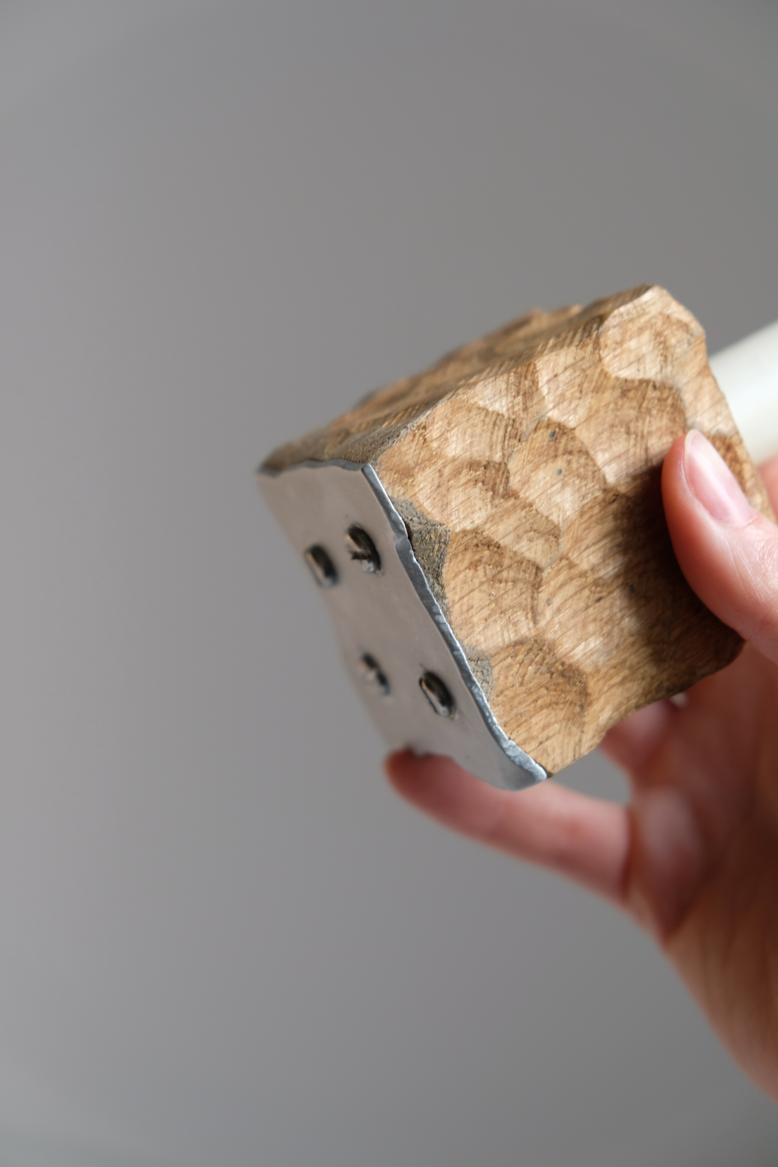 Woman in white dress and gold earrings walking down runway